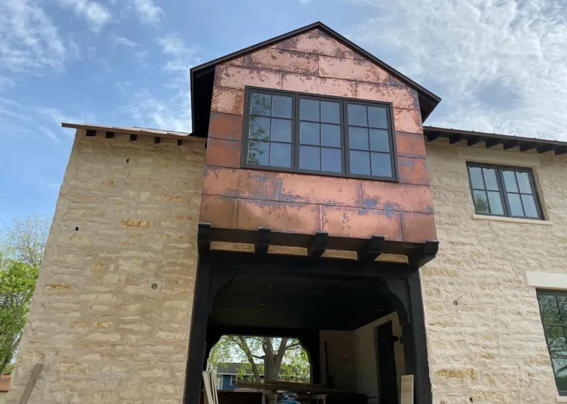 Copper metal panel facade on a stone building for Metal Roof Coating in Four Corners